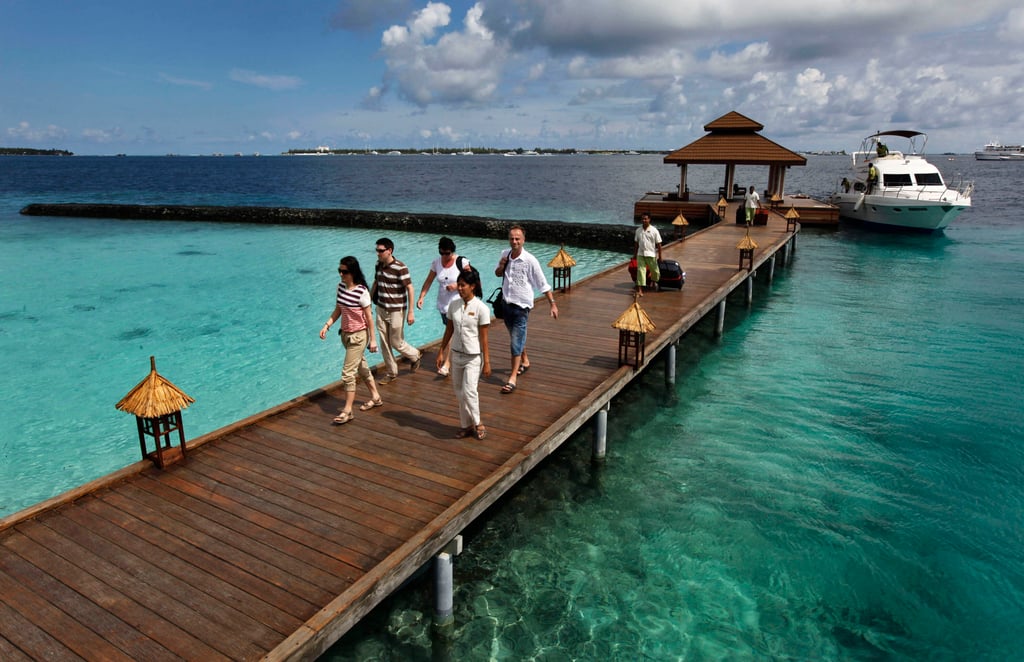 Foreign tourists arrive at a resort in the Maldives. The IMF says the country needs to stabilise its troubled economy, despite a thriving tourism industry. Photo: AP