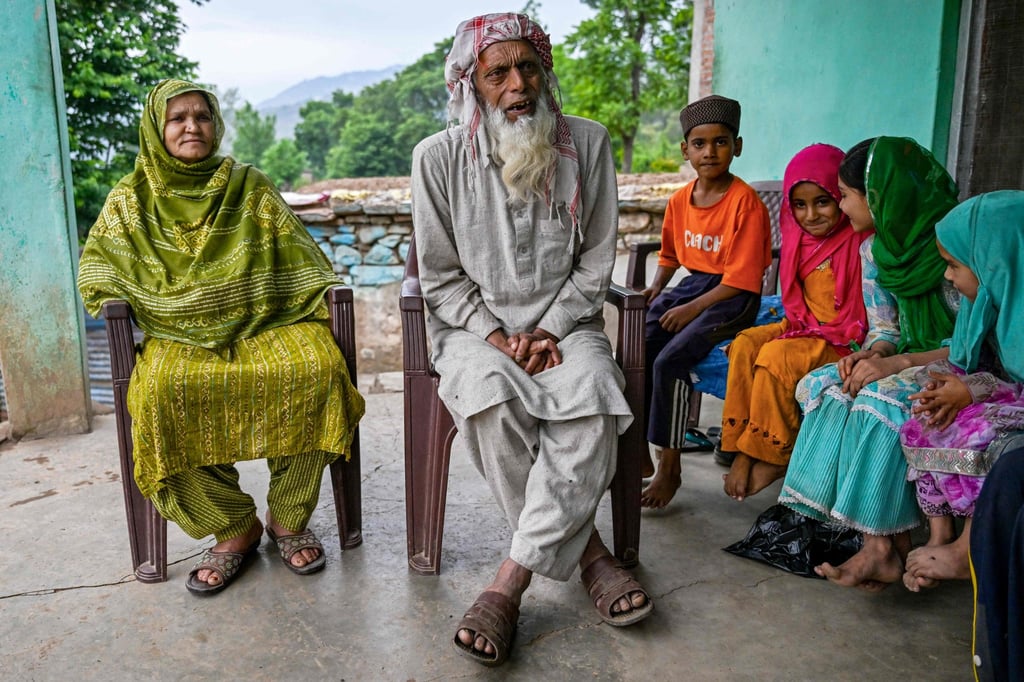Fazal Hussain (second from left) sits beside his wife Nasreen Akhtar Bi (left) and other family members as he speaks after Bi’s aborted deportation to Pakistan. Photo: AFP