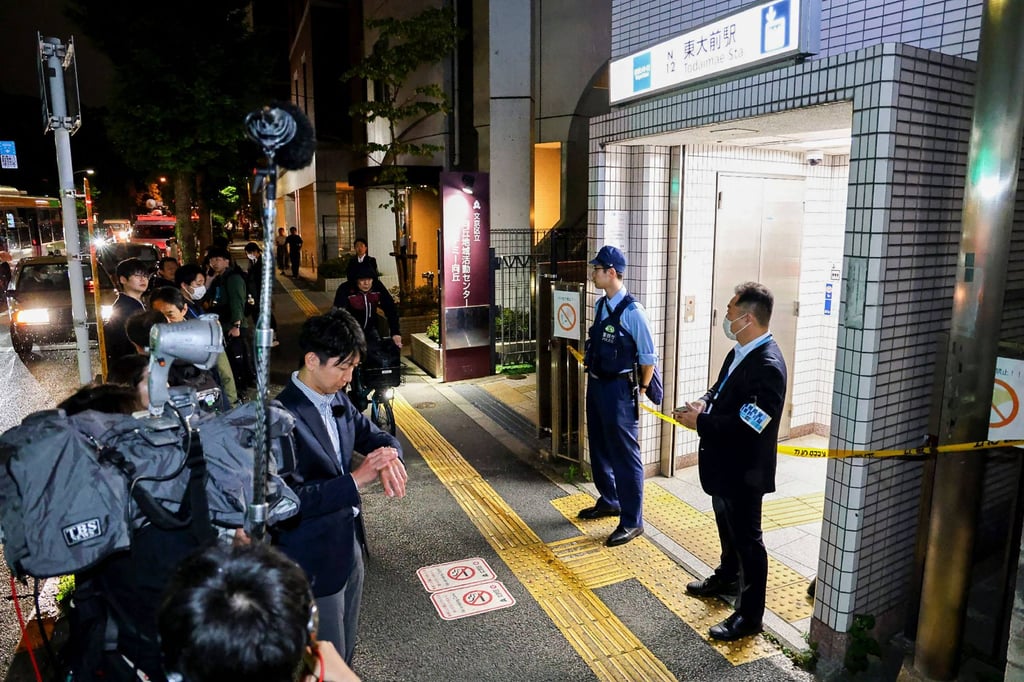 Police officers stand guard at an entrance of Todaimae Station on Tokyo Metro’s Namboku Line after a stabbing incident. Photo: AFP