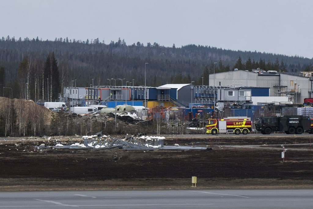 Rescue personnel and vehicles work at the site where the jet crashed. Photo: via AP