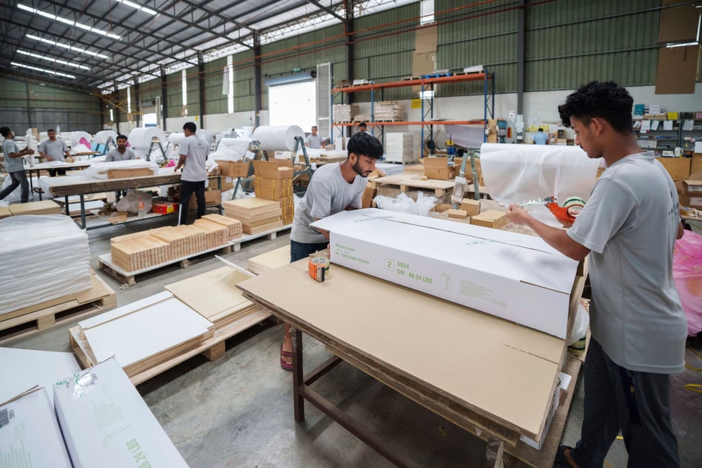 Workers pack furniture for shipping to the United States at a factory on the outskirts of Muar, in Malaysia’s Johor state, in April. Photo: AP