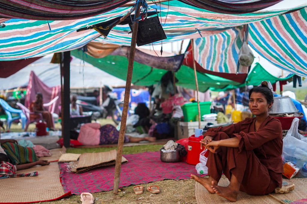 A woman sits inside a shelter in a makeshift tent camp following a strong earthquake in Myanmar. Photo: AP