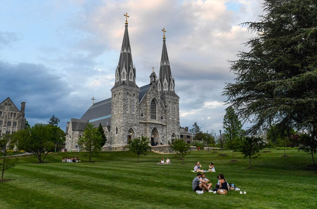 Students sit on the lawn outside St. Thomas of Villanova Church at the campus of Villanova University. The university celebrated as alumnus Cardinal Prevost became Pope Leo XIV. Photo: AFP