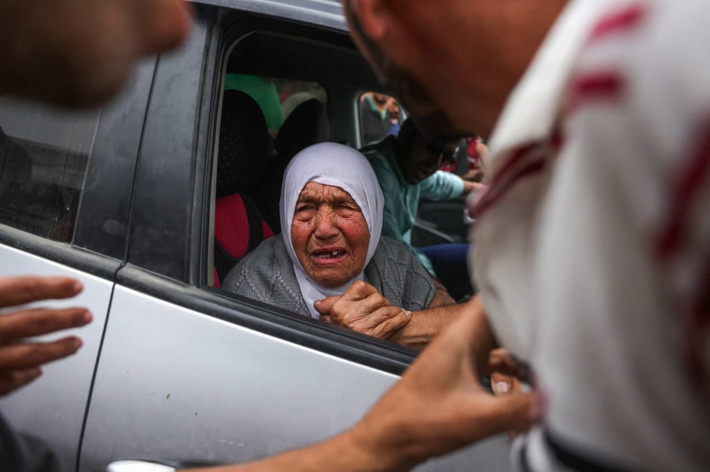 An elderly Palestinian woman reacts to news of relatives following overnight Israeli strikes on the Fatima Bint Asad school in Jabalia, outside the Indonesian Hospital in Beit Lahia in the northern Gaza Strip on Monday. Photo: AFP