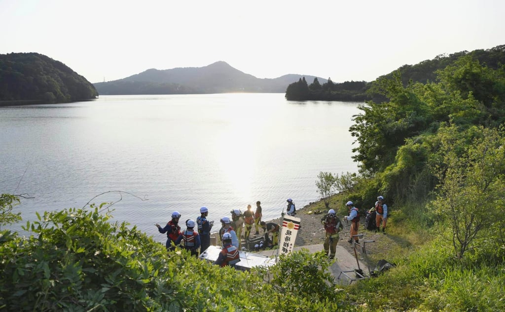 Firefighters gather in Inuyama, central Japan, for a search operation as a Japanese air force plane crashed after taking off for a training flight. Photo: via AP