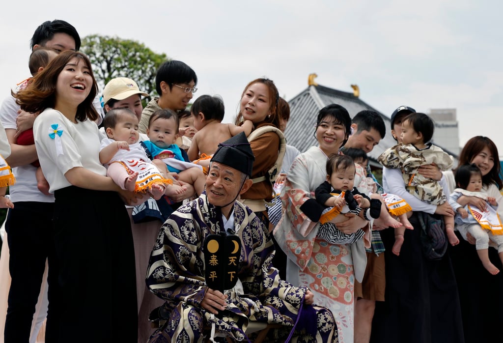 Parents hold their babies before participating in a baby crying contest in Tokyo. Photo: EPA-EFE