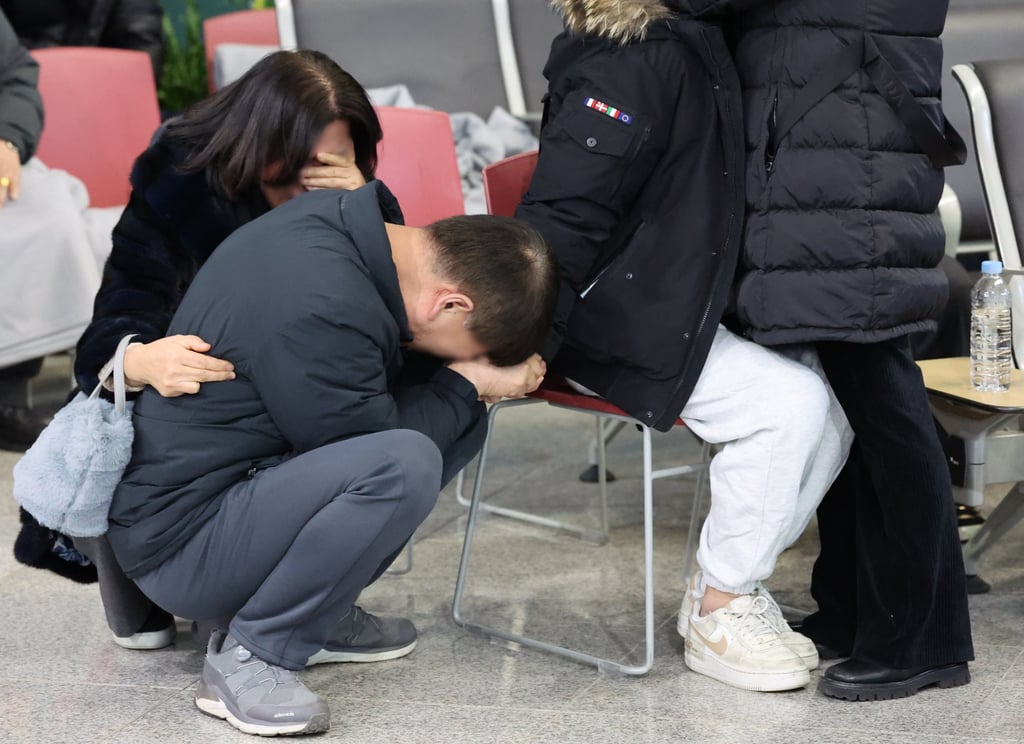 Family members of a victim of the Jeju Air plane crash grieve at Muan International Airport in South Korea on December 29 last year. Photo: Yonhap/EPA-EFE