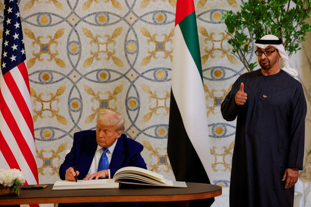 US President Donald Trump signs a guest book next to UAE President Sheikh Mohamed bin Zayed al-Nahyan. Photo: Reuters