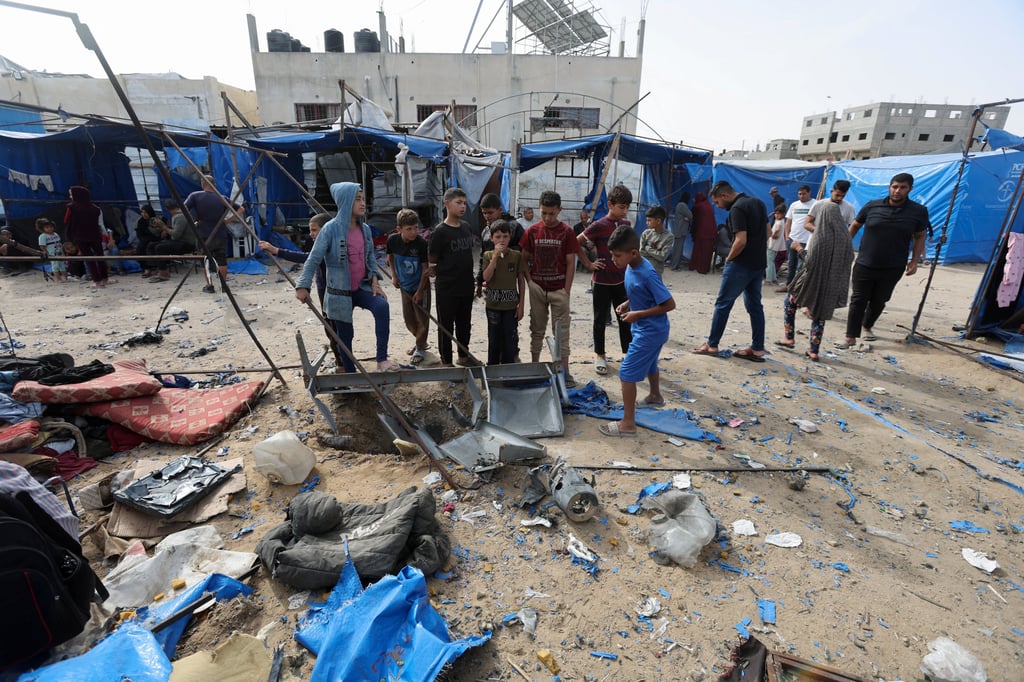 Palestinians inspect the site of an Israeli air strike in Deir Al-Balah in the central Gaza Strip on Saturday. Photo: Reuters