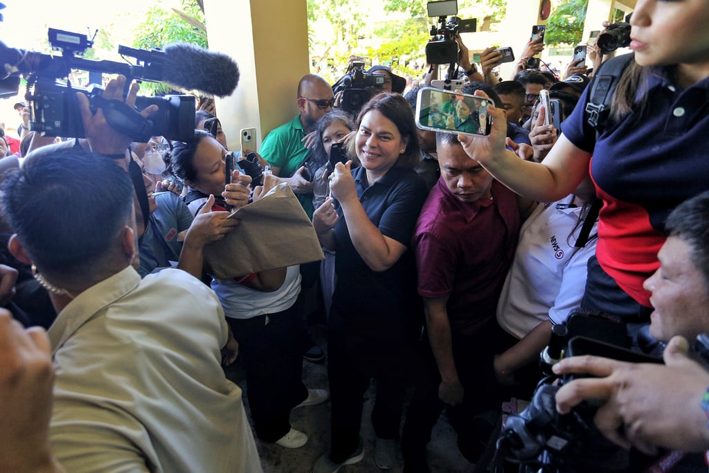 Philippine Vice-President Sara Duterte-Carpio (centre) arrives to cast her vote at a polling centre in Davao City on May 12. Her approval rating rose seven percentage points ahead of the midterm election. Photo: AP