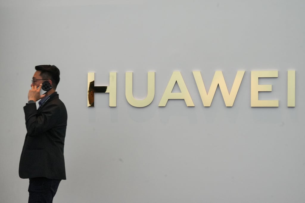 A man speaks on the phone near a Huawei logo during a product launch in Kuala Lumpur, Malaysia, February 18, 2025. Photo: EPA-EFE