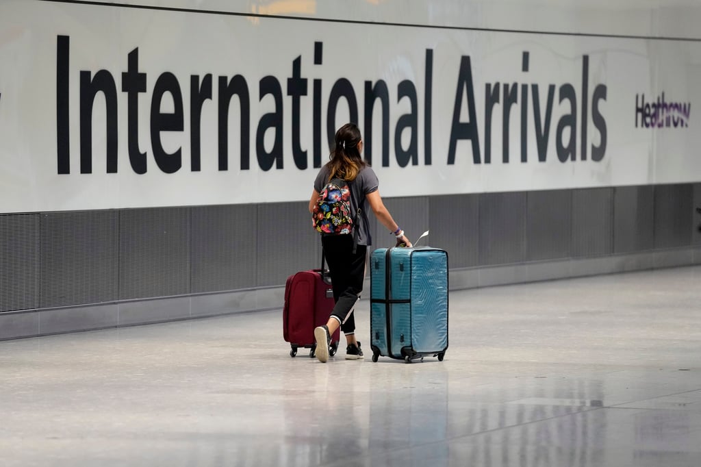 A passenger arrives after disembarking from a flight at Heathrow Airport in London. Photo: AP