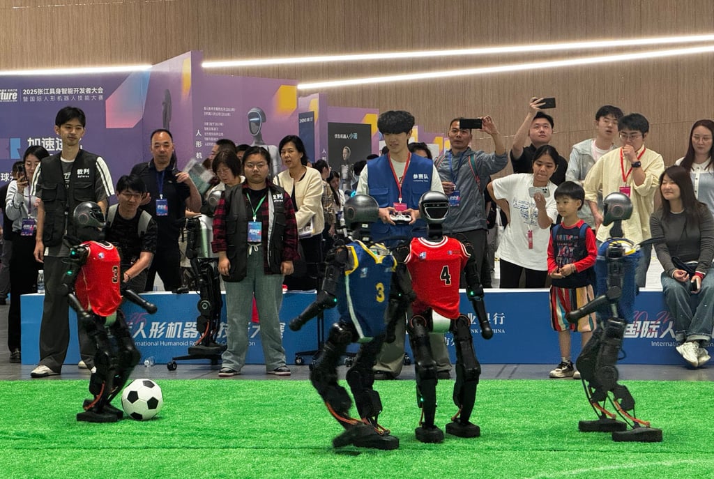 Humanoid robots play soccer at an event in Shanghai on Thursday. Photo: Wency Chen