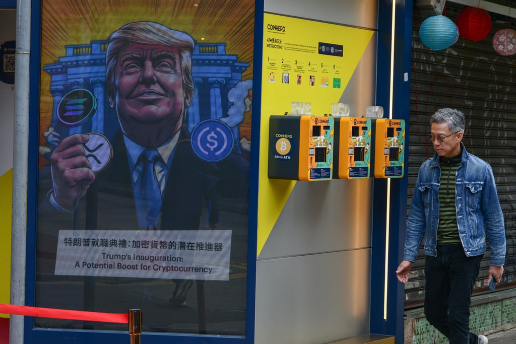 Pedestrians walk past a likeness of US President Donald Trump at a crypto exchange in Hong Kong on January 31. Photo: Antony Dickson