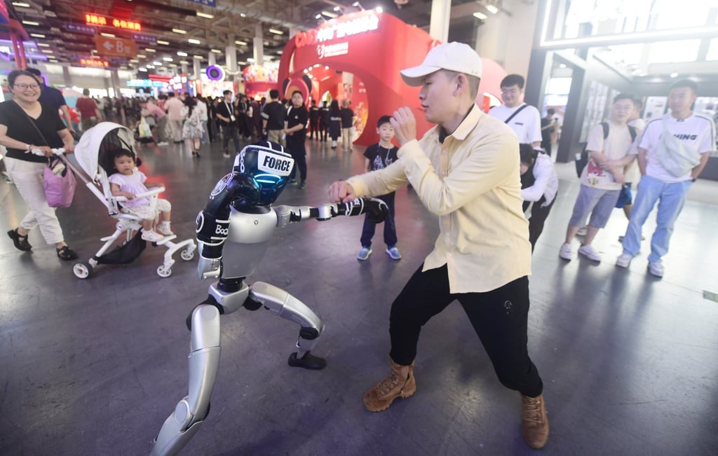 A man engages in a boxing match with the Unitree G1 humanoid robot at the 21st China International Cartoon & Animation Festival in Hangzhou, Zhejiang province, China on May 29, 2025. Photo: CFOTO/Future Publishing via Getty Images