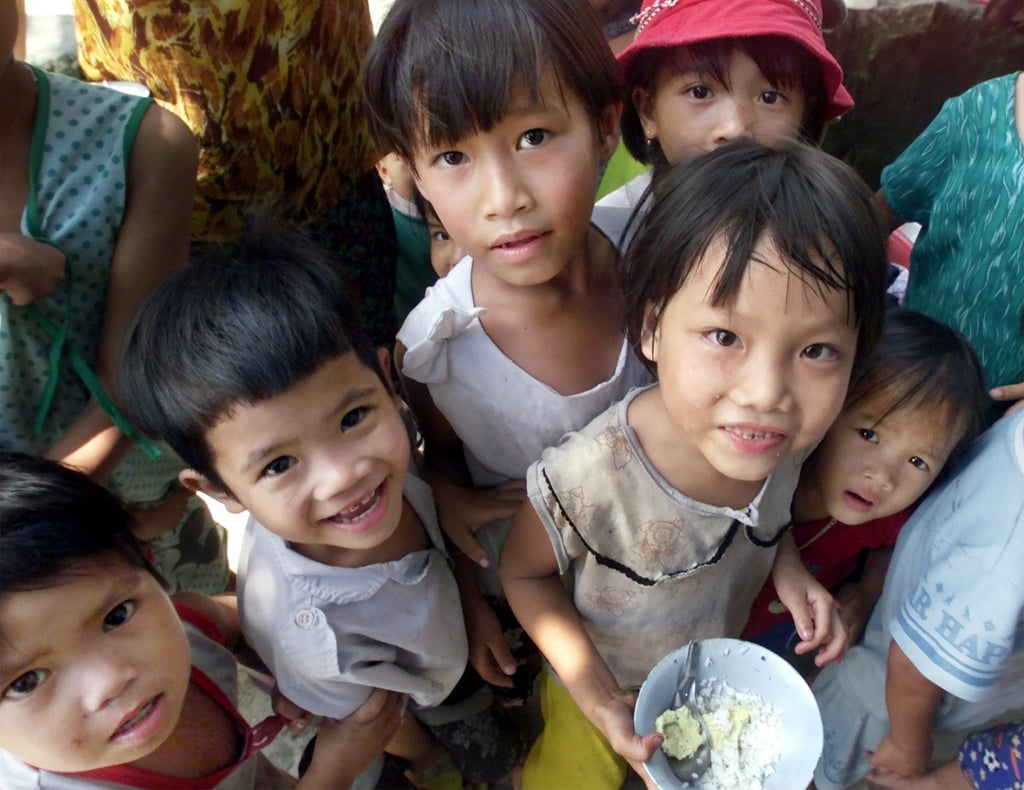 A group of Vietnamese children gather around a photographer. Photo: AP