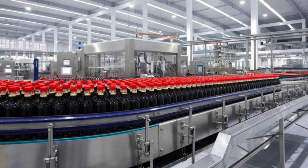 Bottles of soy sauce on a conveyor belt inside a Foshan Haitian factory. Photo: Handout