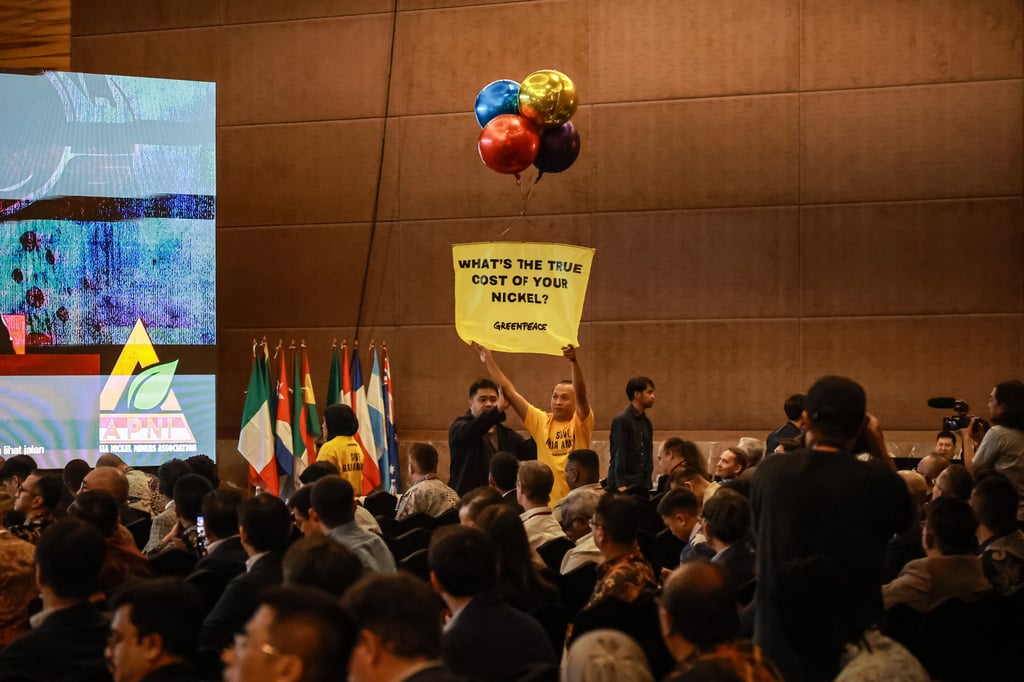 Greenpeace Indonesia activists and four young Papuans stage a protest at the Indonesia Critical Minerals expo on June 3. Photo: Greenpeace Indonesia