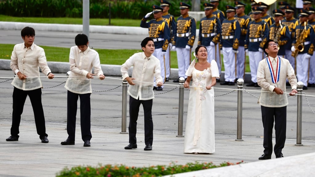 Marcos (right) and his family lead Independence Day flag-raising and wreath-laying rites at the Jose Rizal monument on Thursday. Photo: EPA-EFE