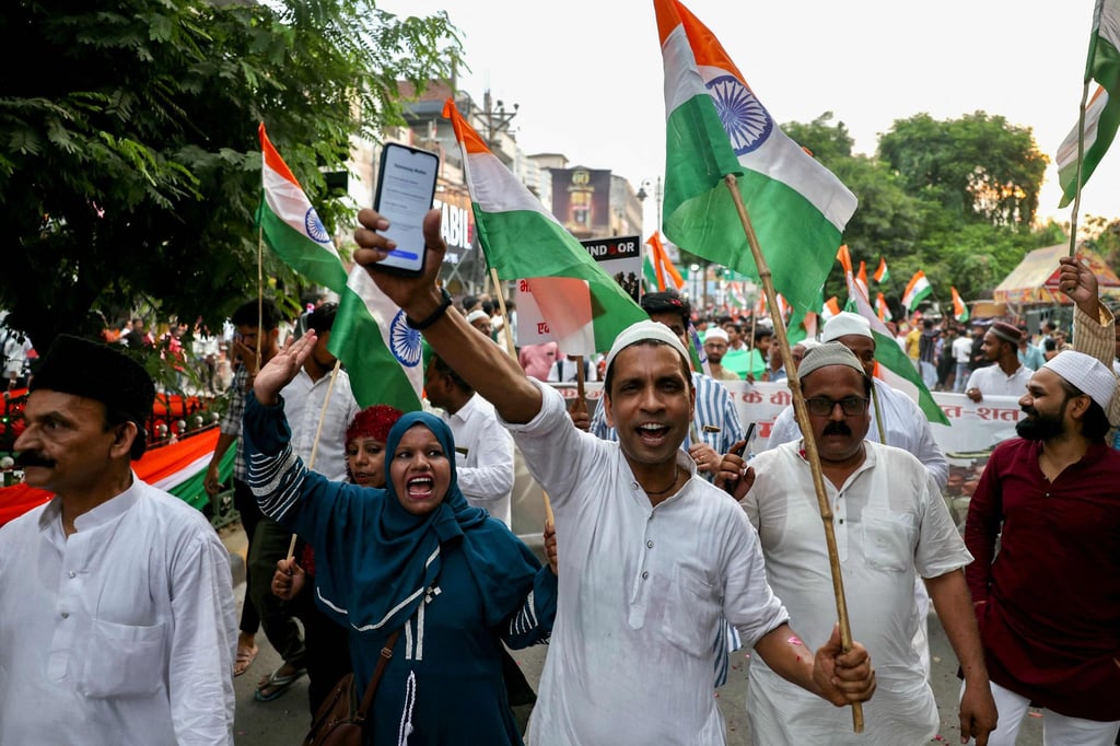 People carry India’s national flag as they take part in a rally on May 24 to express solidarity with the country’s armed forces after India and Pakistan agreed to a ceasefire. Photo: AFP