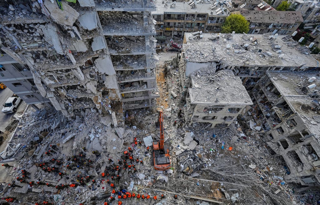 Israeli soldiers search through the rubble of residential buildings destroyed by an Iranian missile strike in Bat Yam, central Israel, on Sunday. Photo: AP