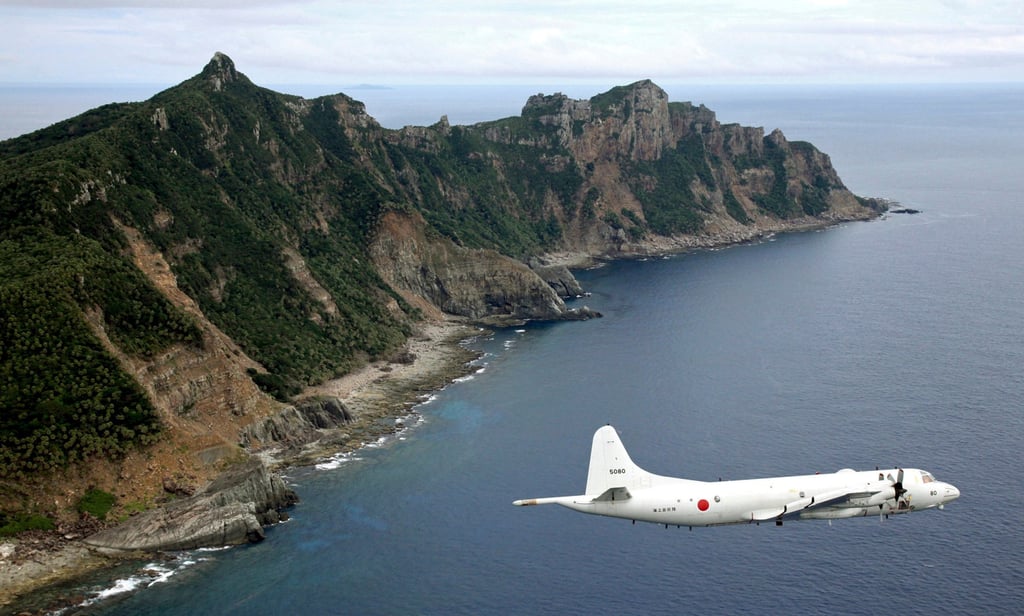 A Japan Maritime Self-Defence Force surveillance plane flies over the disputed Diaoyu Islands. The islands, long a flashpoint in Sino-Japanese ties, are controlled by Tokyo but claimed by Beijing. Photo: AP