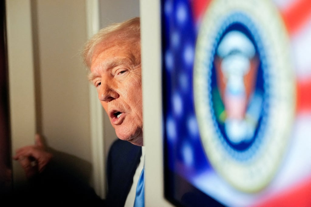 US President Donald Trump talks to members of the press aboard Air Force One. Photo: Reuters
