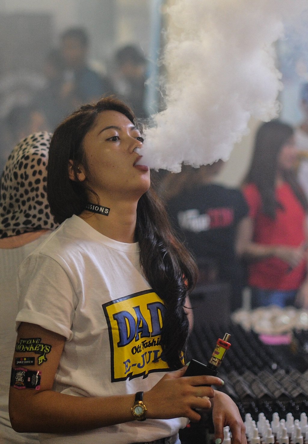 A promoter smokes an e-cigarette at a vape expo in Kuala Lumpur in 2015. Photo: AFP