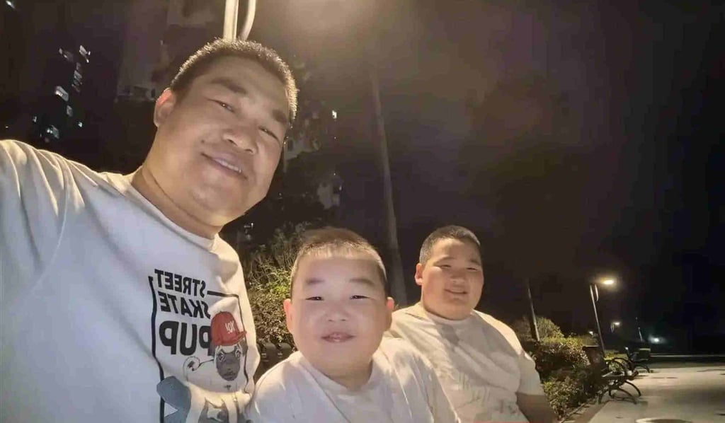 Seeing the funny side: The father and sons outside after their video went viral on social media. Photo: Baidu