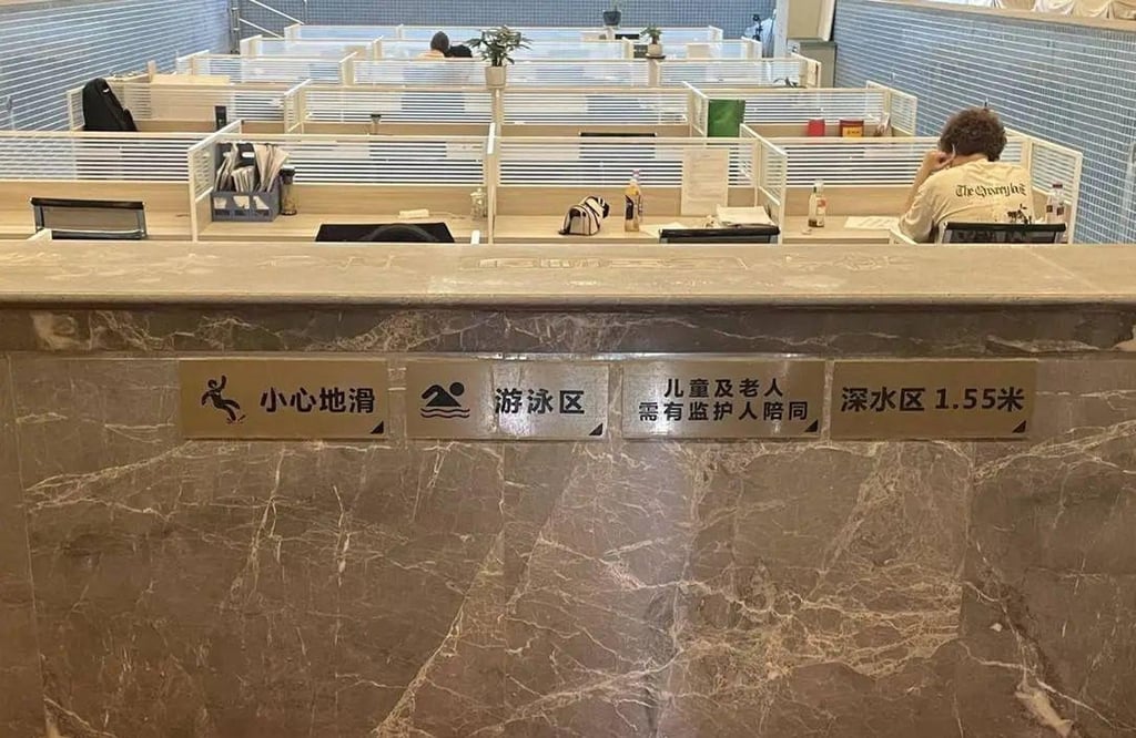 Company staff get down to work with the original swimming pool safety signs clearly visible. Photo: handout