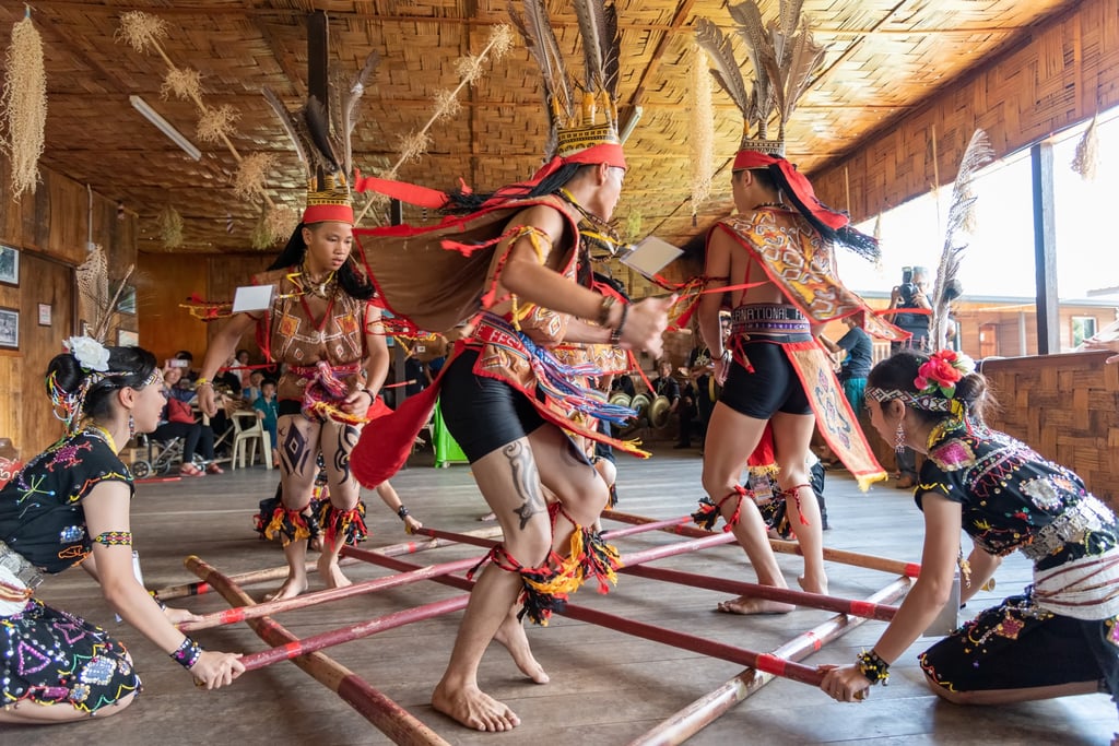 A native bamboo dancing performance during a harvest festival in Malaysia’s Sabah state. All three husbands have embraced the country’s culture. Photo: Shutterstock