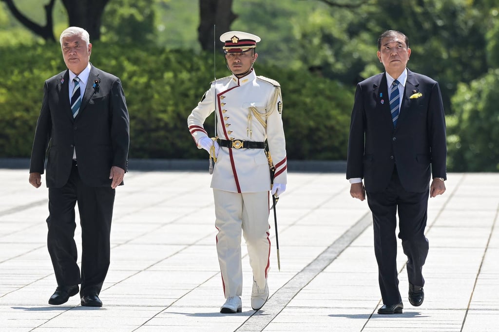 Japan’s Defence Minister Gen Nakatani (left) and Prime Minister Shigeru Ishiba (right) after inspecting an honour guard at the Ministry of Defence in Tokyo on June 30. Photo: AFP