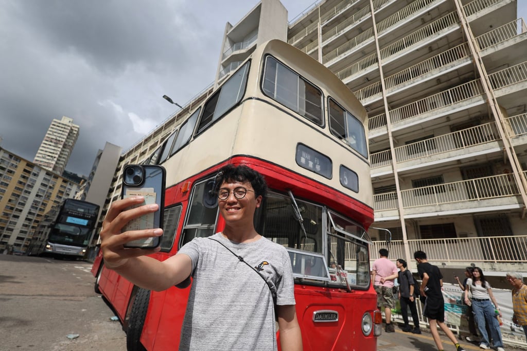 Artist Swing Lam takes a photo with the former route 45 bus at the estate. Photo: Dickson Lee