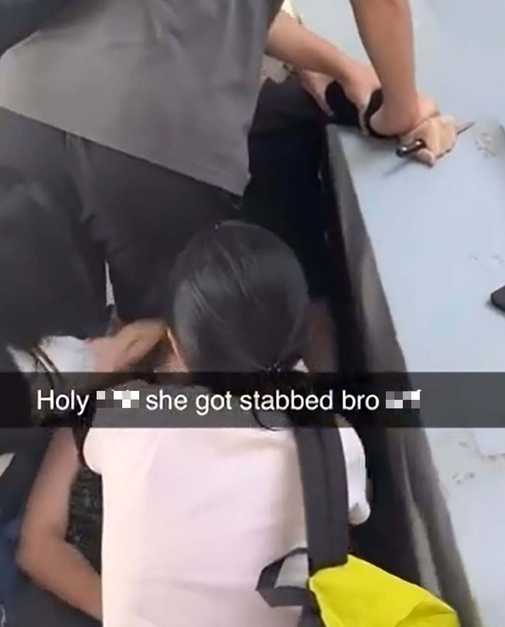 A screengrab of a social media video shows the suspect, a Chinese national, being restrained as friends try to help the victim following a knife attack at Taylor’s University in Malaysia on Monday. Photo: Reddit