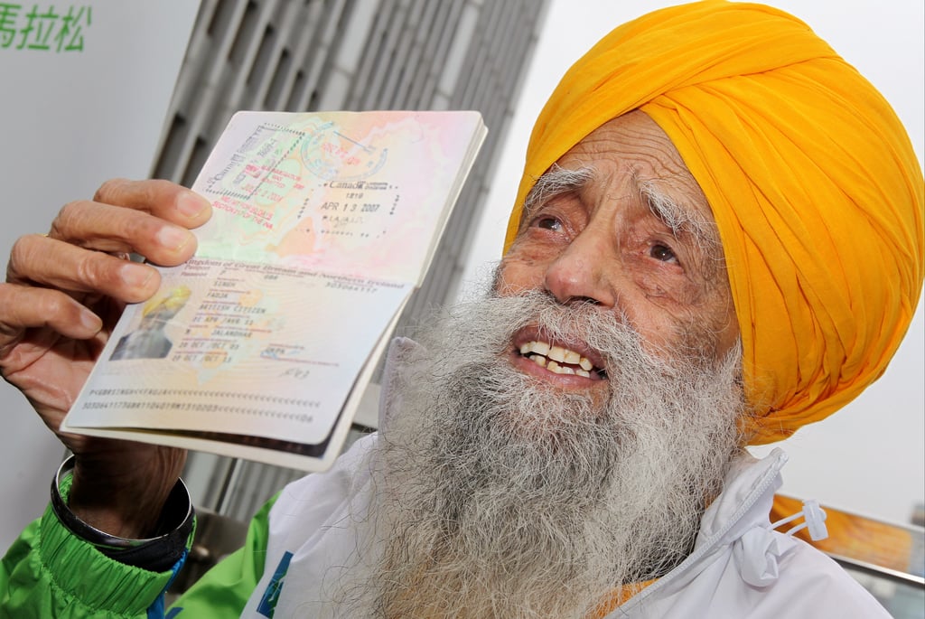 Fauja Singh, then 101, shows his passport in Causeway Bay ahead of a 10km race at the Hong Kong Marathon event. Photo: K. Y. Cheng