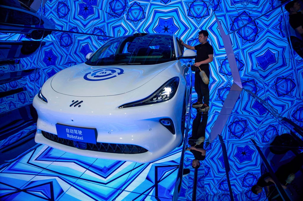 A worker cleans a robotaxi in Shanghai. Photo: AP