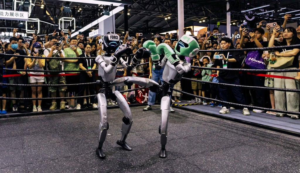 Visitors outside a ring watch a pair of remote-controlled G1 humanoid robots from Unitree Robotics engage in a kickboxing match at the World Artificial Intelligence Conference in Shanghai on Monday. Photo: EPA