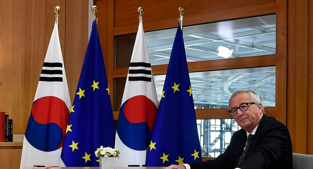 EU and South Korean flags at a summit meeting in 2018 with then European Commission president Jean-Claude Juncker. Photo: AFP