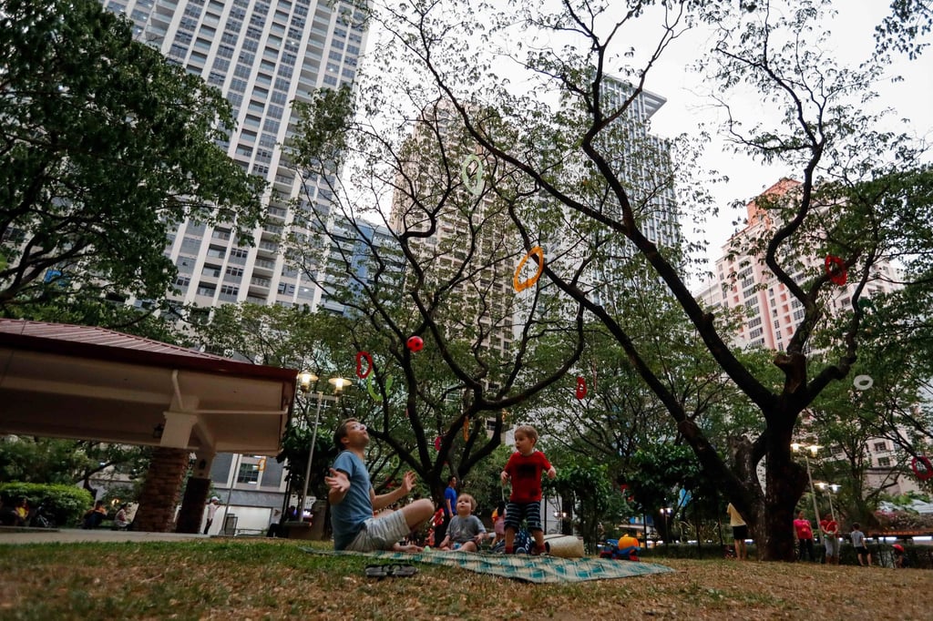 A family plays with a ball at a pocket park on private land in Makati, south of Manila, in 2019. Marcos urged local governments to revitalise public parks and plazas. Photo: EPA-EFE