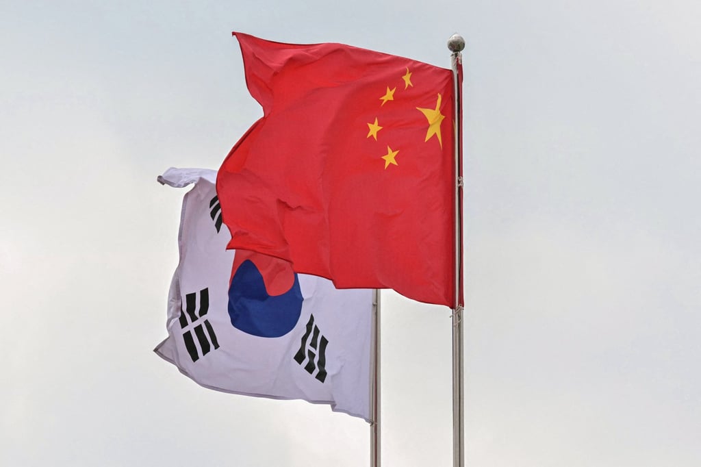 The national flags of South Korea and China flutter in the wind before the arrival of Chinese Premier Li Qiang in Seoul last year. Photo: AFP