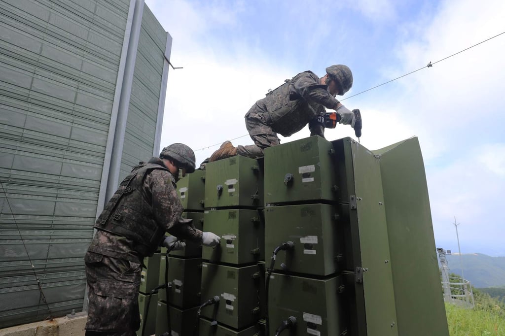 Soldiers dismantle propaganda loudspeakers aimed at North Korea on Monday. Photo: South Korean Defence Ministry