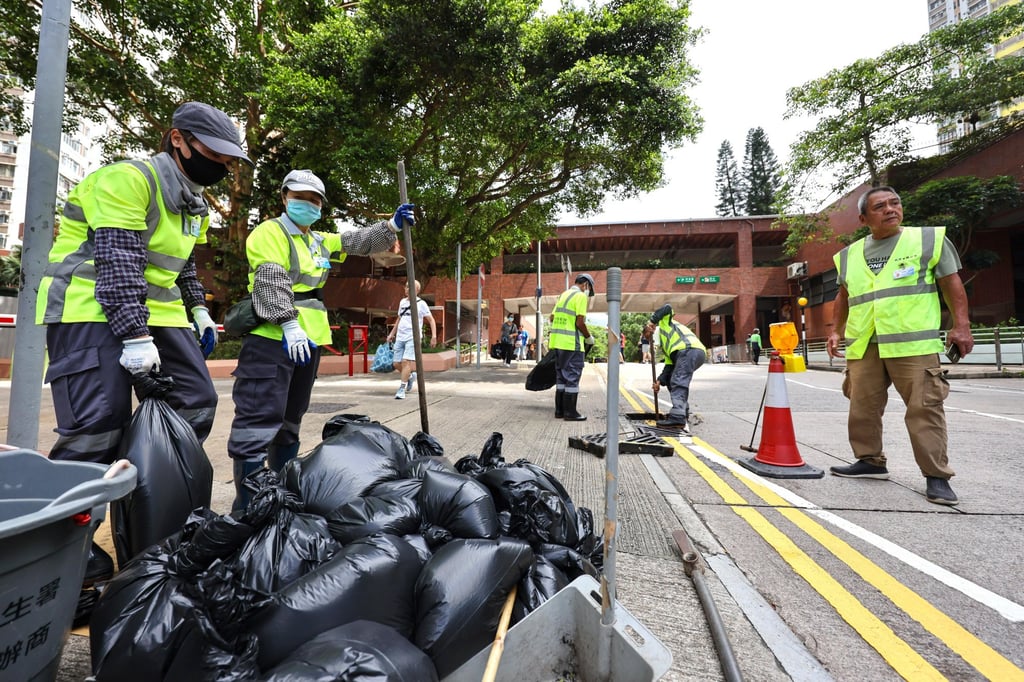 Workers clear sewage drains around Lei Tung Estate. Photo: Karma Lo