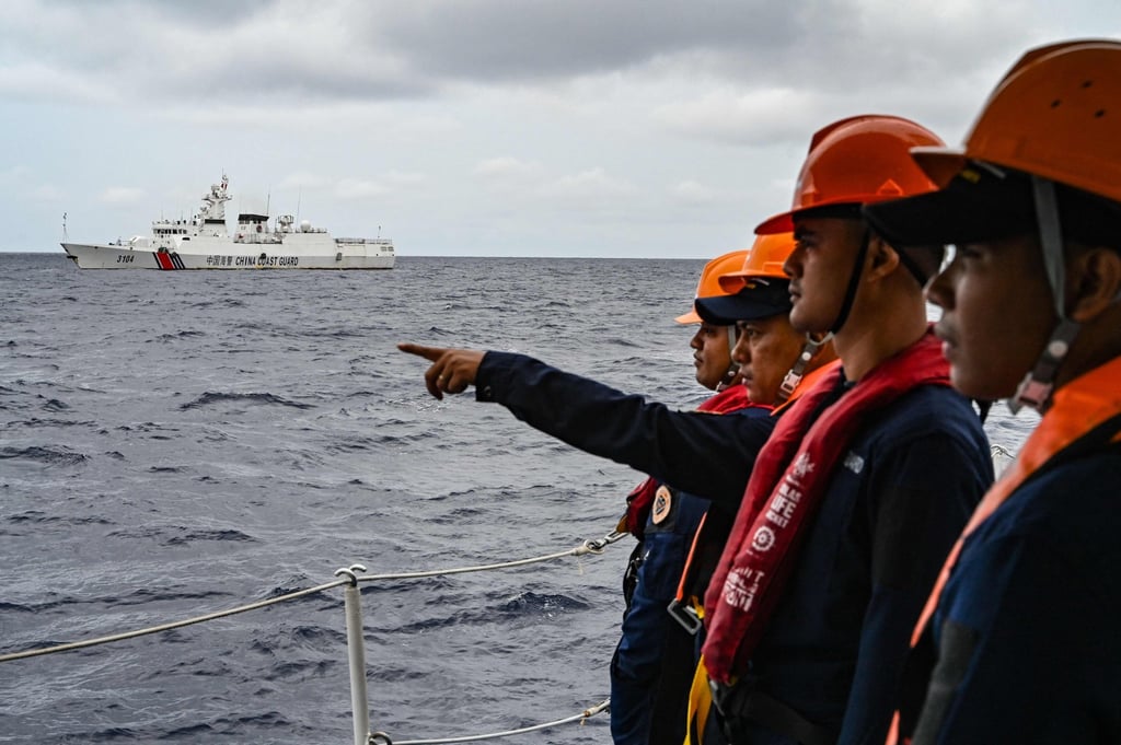 Members of the Philippine coastguard monitor a Chinese coastguard vessel in disputed waters of the South China Sea last year. Photo: AFP