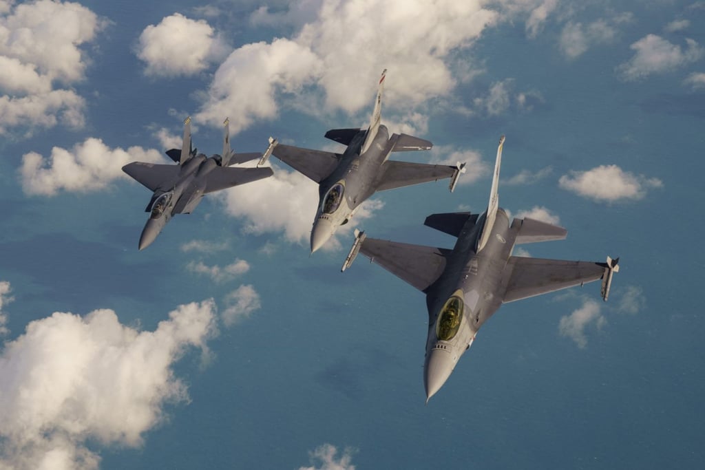 An RSAF F-15 air-superiority fighter (centre) and two F-16s fly in formation over the South China Sea in 2018. Photo: AFP