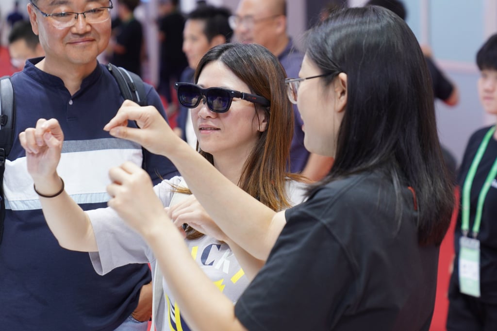 Visitors try on smart glasses during the third China International Supply Chain Expo in Beijing last month. Photo: Xinhua