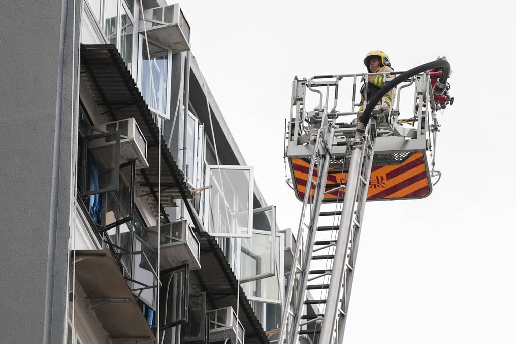 An extendable ladder is used at the scene. Photo: Eugene Lee