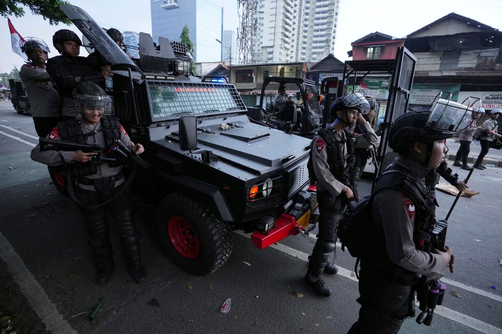 Riot police take up positions during the protests in Jakarta, Indonesia on Monday. Photo: AP