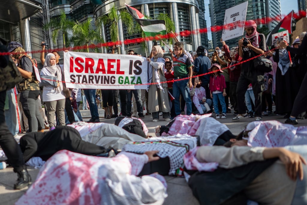 Protesters lay on the ground during a rally for Gaza in Kuala Lumpur earlier this month. Photo: EPA