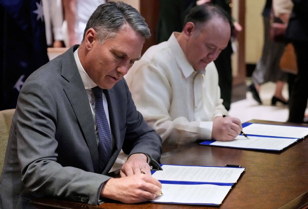 Marles (left) and Teodoro Jnr sign a statement of intent for the enhanced defence cooperation agreement on Friday. Photo: AP