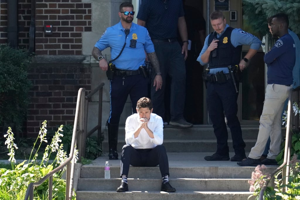 Minneapolis Mayor Jacob Frey sits on the steps of the Annunciation Church’s school as police respond to a shooting on Wednesday. Photo: AP